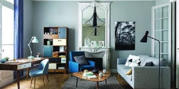 Image that shows a living room of a home with modern furnitures having paleblue colored background