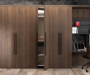 Modern wooden wardrobe with a built-in study desk, open shelves, and a stylish office chair in a well-designed room.